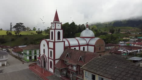 aerial view of a church and village in a mountainous landscape
