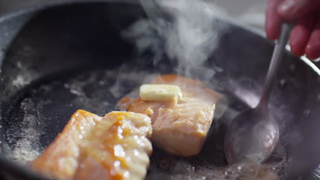 cooking fish fillet with butter in frying pan