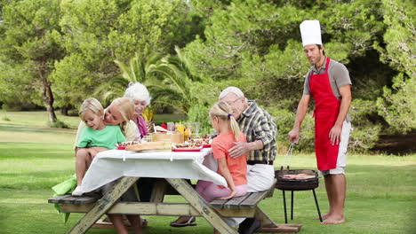 man cooking a bbq for family