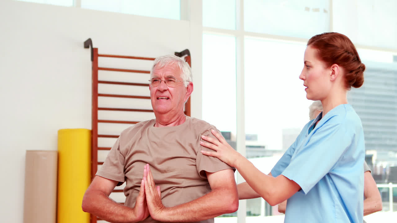 Injured senior citizen exercising with physiotherapist
