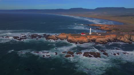 point arena historic landmark museum red building lighthouse california aerial drone stoneboro manchester beach shoreline highway pacific ocean fort brag san fran big sur daytime sunny static shot