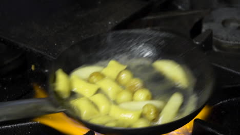 fresh agnolotti pasta in frying pan with parsnips and potatoes second closeup shot