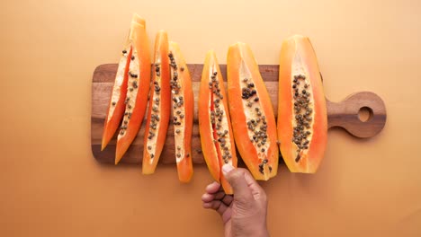 Slice-of-papaya-on-white-plate