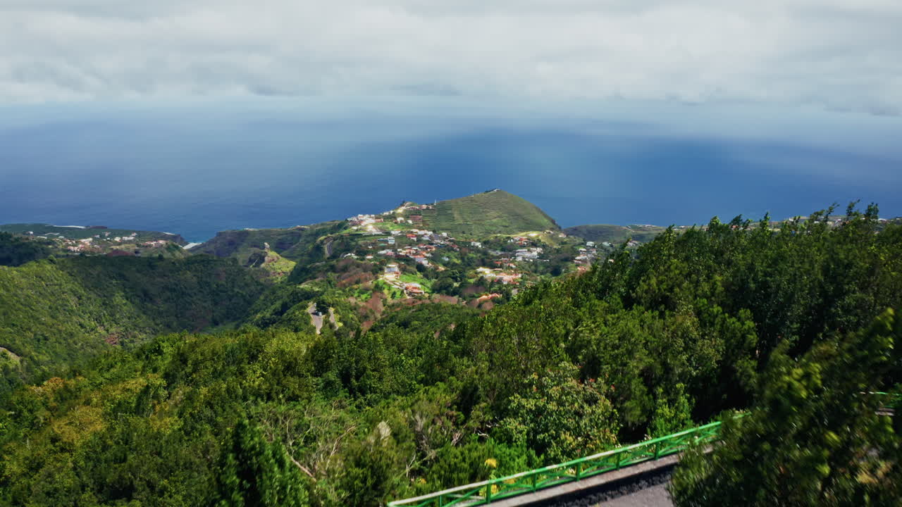 Aerial drone shot of the picturesque landscape in La Palma, Canary Islands. High view of the green lush vegetation, the coastline and the deep blue ocean.