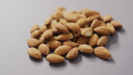 video of almonds on grey background