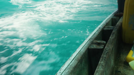 view from boat cutting through frothy ocean waves