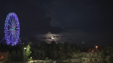 night ferris wheel under a cloudy moon