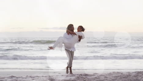 Animation-Von-Lichtpunkten-über-Einem-Glücklichen-Afroamerikanischen-Bräutigam,-Der-Die-Braut-Bei-Der-Hochzeit-Am-Strand-Trägt