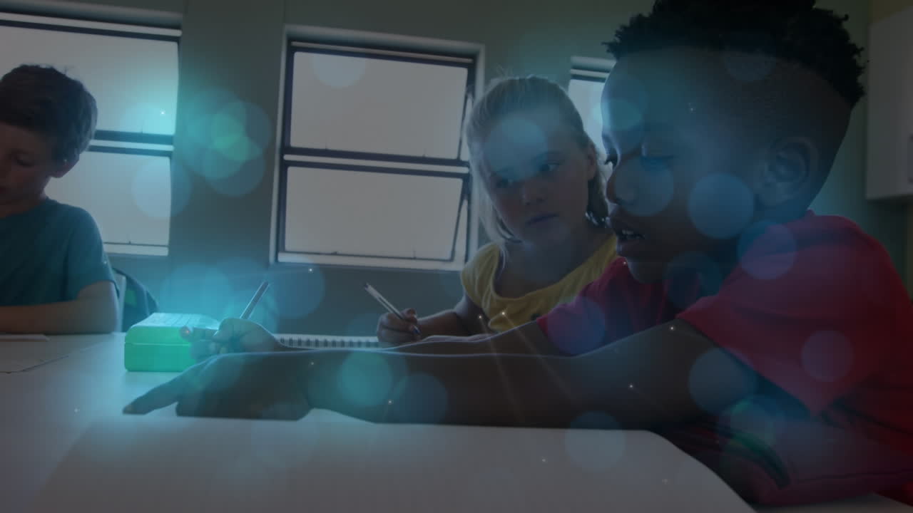 Blue spots of light against diverse boy and girl studying together in the class at school