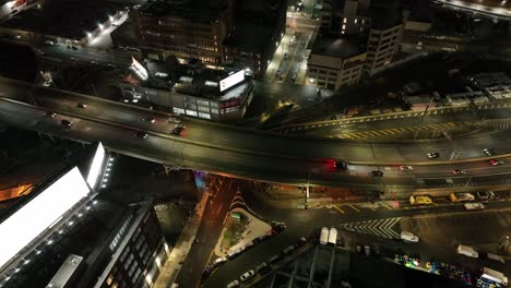 an aerial view above the entrance of the midtown tunnel in new york at night