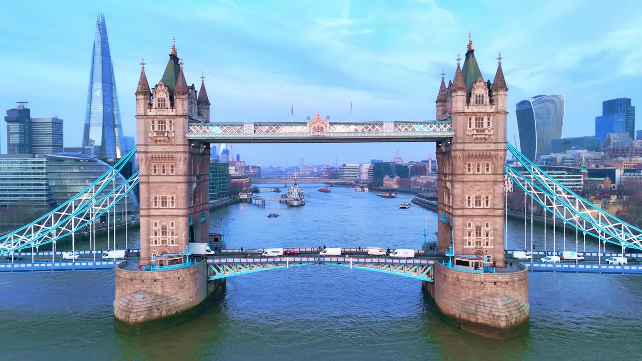 Traffic moves across Tower Bridge as people enjoy sightseeing in the city