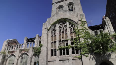 Abandoned-historic-City-Methodist-Church-in-Gary,-Indiana-with-gimbal-video-tilting-down-in-slow-motion