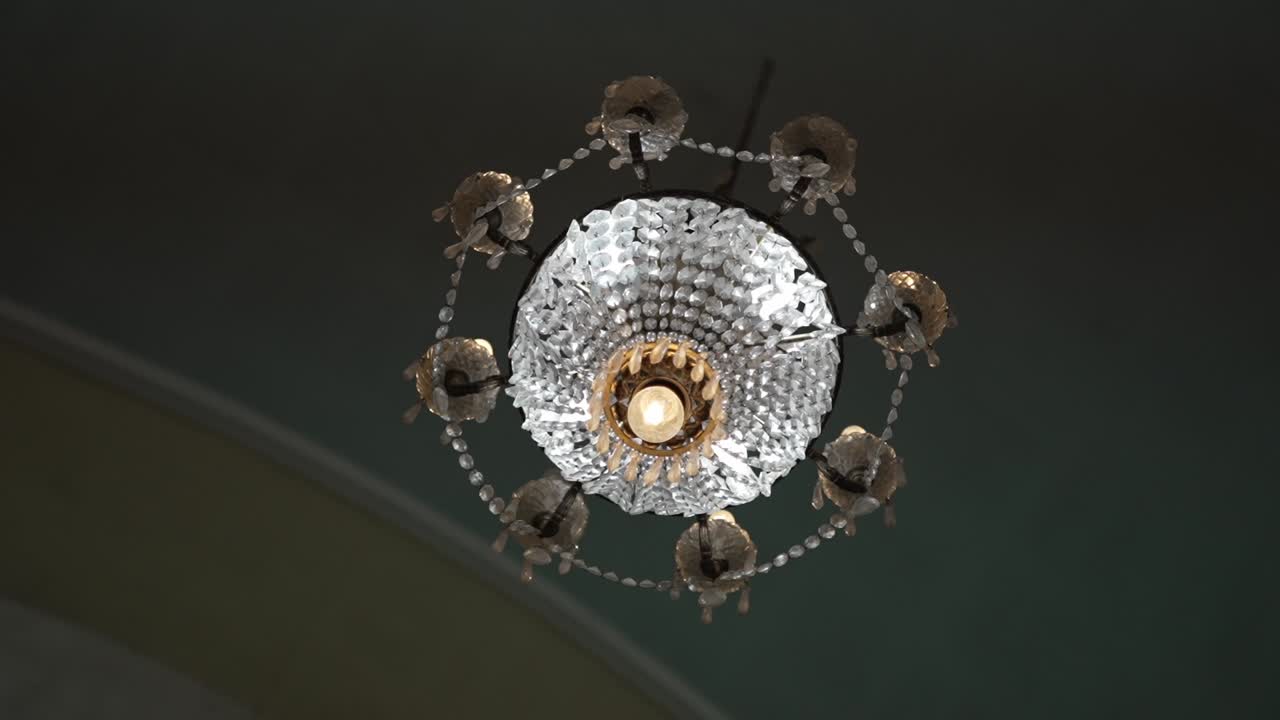 ornate crystal chandelier with intricate details, captured from a low-angle perspective