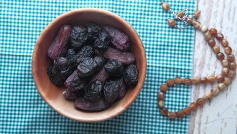 person hand taking date fruit from a bowl