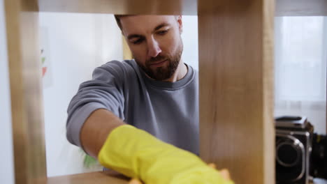 man cleaning the bookshelf