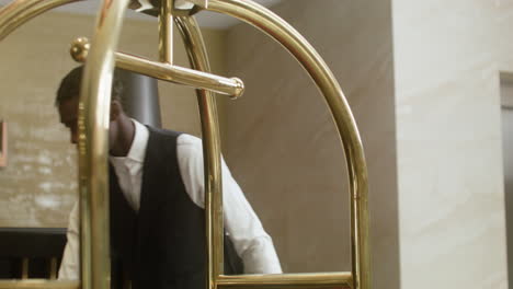 bellhop placing luggage on a hotel cart