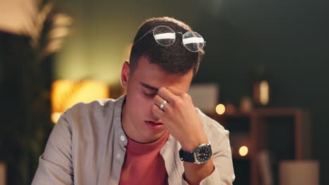 tired man with glasses and a watch