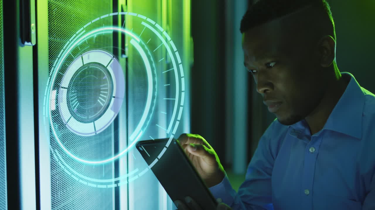 Animation of processing circle over african american man working with tablet and servers