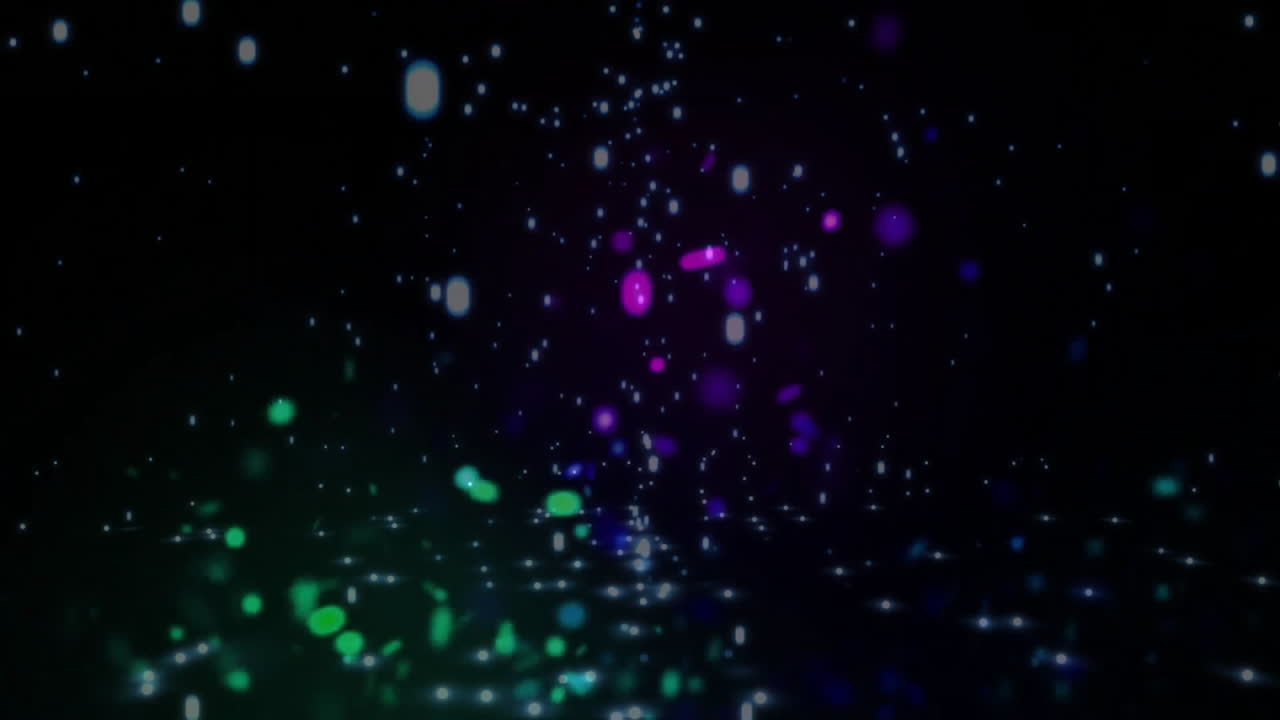 Colorful particles floating and glowing, abstract animation over dark background