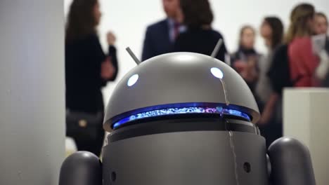 a unique android robot at an art exhibition, observing guests and creating a futuristic atmosphere, blending technology and creativity in a modern setting