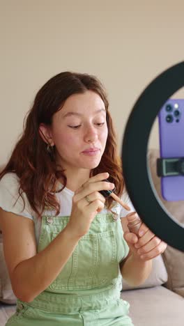 woman applying makeup with ring light