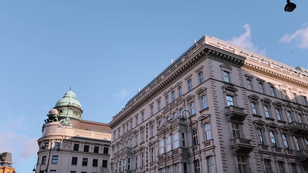 Elegant historic buildings in Vienna, Austria, under a bright blue sky