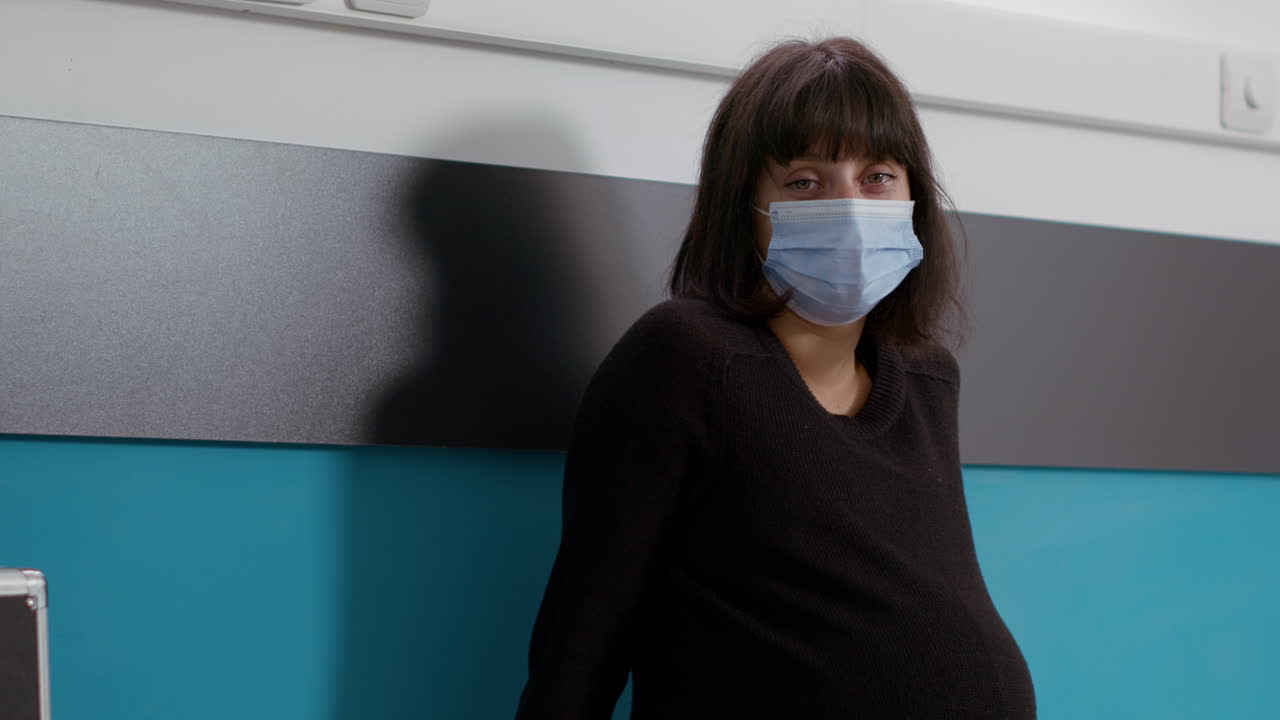 Portrait of female patient expecting baby in medical office