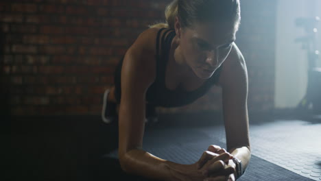 woman doing a plank exercise in a gym