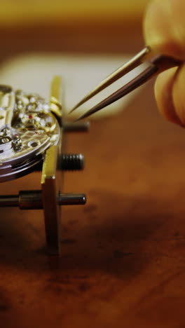 close-up of horologist hands repairing a watch