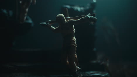 a miniature mummified doll hanging on the gallows at night