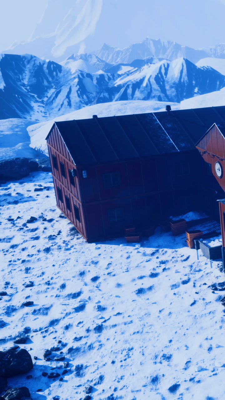 Mountain cabin nestled in snowy wilderness with majestic peaks in the distance