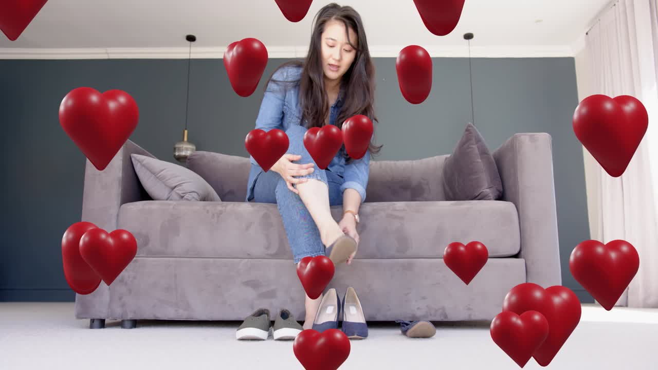 Mid adult woman removing slipper and trying navy heel, choosing fashion while red hearts overlaying