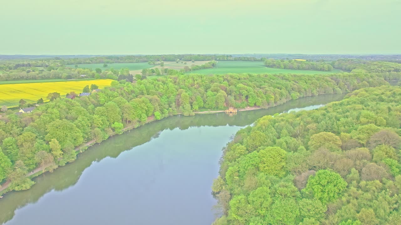 Establishing drone shot of Newmillerdam Country Park lake during the day in Newmillerdam, suburb of Wakefield, West Yorkshire, England