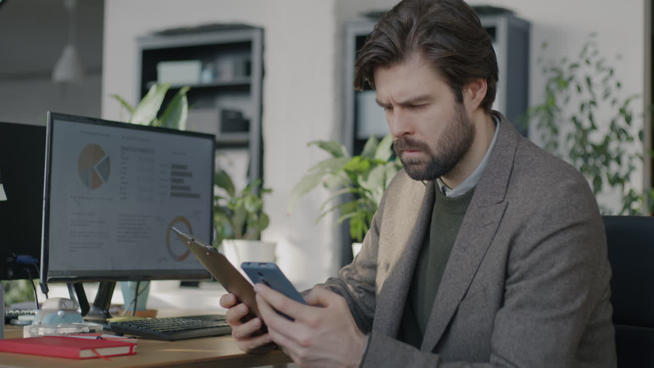 Businessman working on a tablet and smartphone in the office