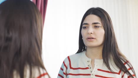 dissatisfied young woman is unhappy in front of the mirror.