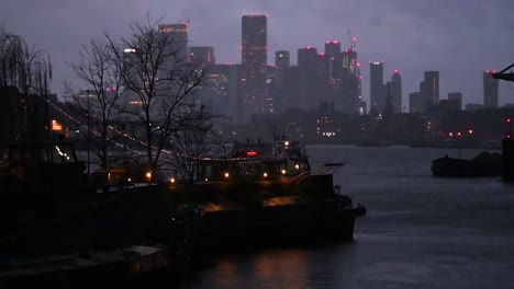 boats sailing out of central london towards canary wharf in the evening, london, united kingdom