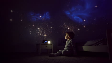 child watching a star projector displaying a galaxy in a dark bedroom