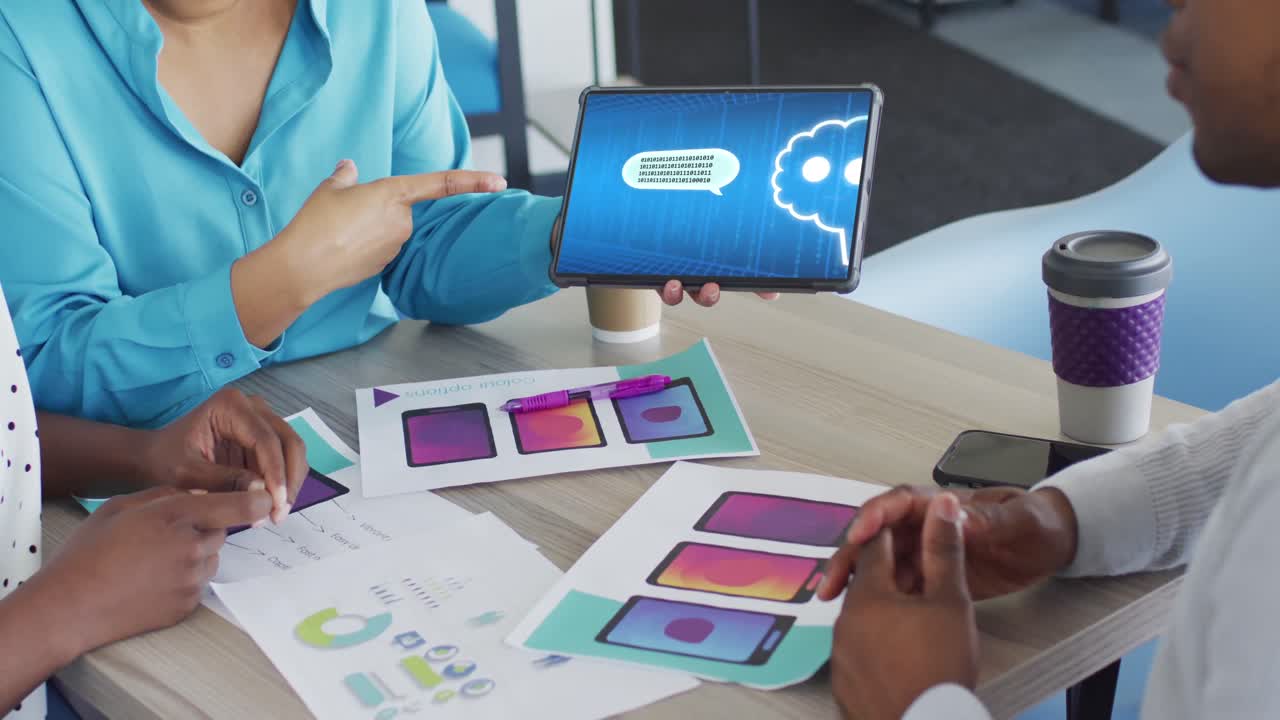 Diverse business people in office using tablet with data processing on screen