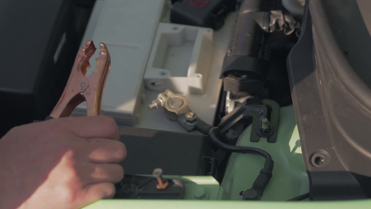 cargar la batería del coche con electricidad a través de cables de conexión. el concepto de reparación de automóviles.