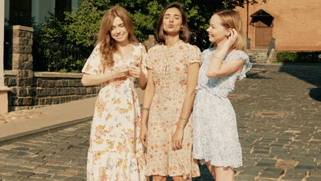 three women laughing on a city street