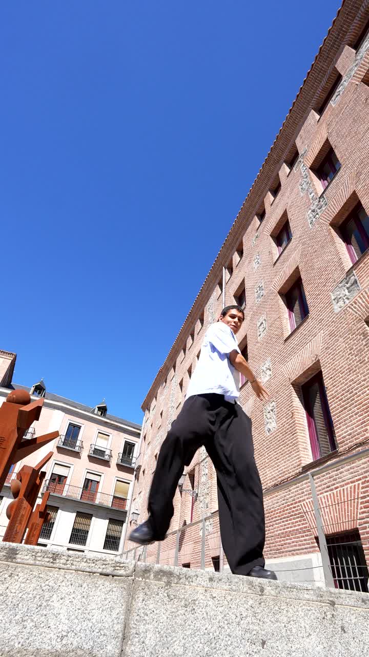 Man Posing in Front of Brick Building
