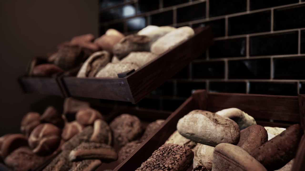A close up of a bakery display full of loaves of fresh bread.