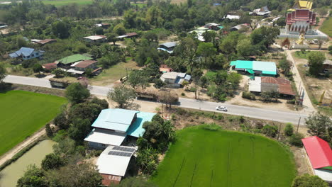 trucks full of hay drive through rural phitsanulok thailand drone track left 4k 60fps