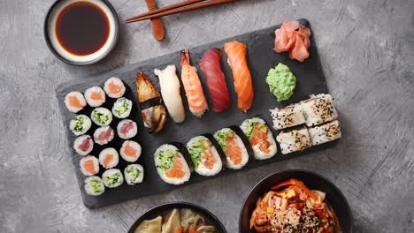 Various-kinds-of-sushi-placed-on-black-stone-board