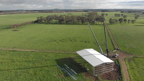 two cranes holding up finished store house framework