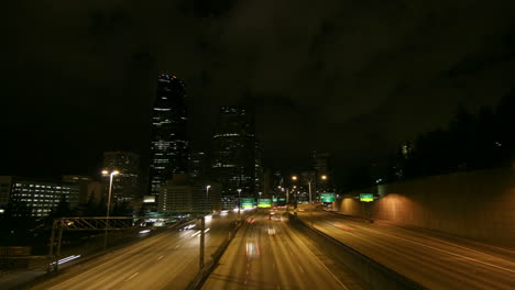 a beautiful shot of time lapsed freeway traffic in a downtown area