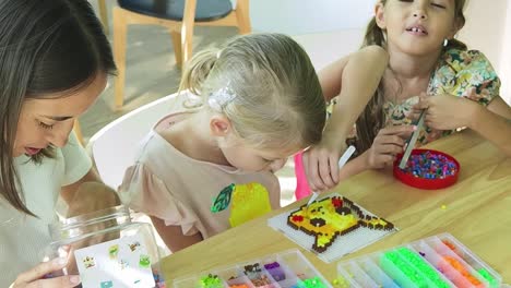 mother and daughters crafting together