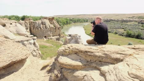 Caucasian-male-photographer-takes-photo-of-hoodoos-with-DSLR-camera