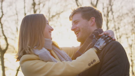 Portrait-Of-Romantic-Couple-With-Woman-With-Prosthetic-Hand-Hugging-in-Winter-Or-Autumn-Countryside