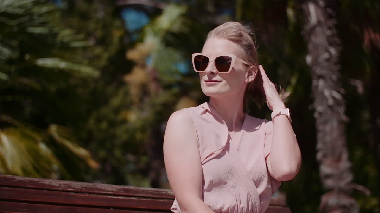 Smiling Woman in Park with Blooming Palms